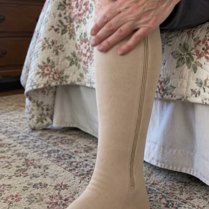 A zipped beige compression sock on a leg